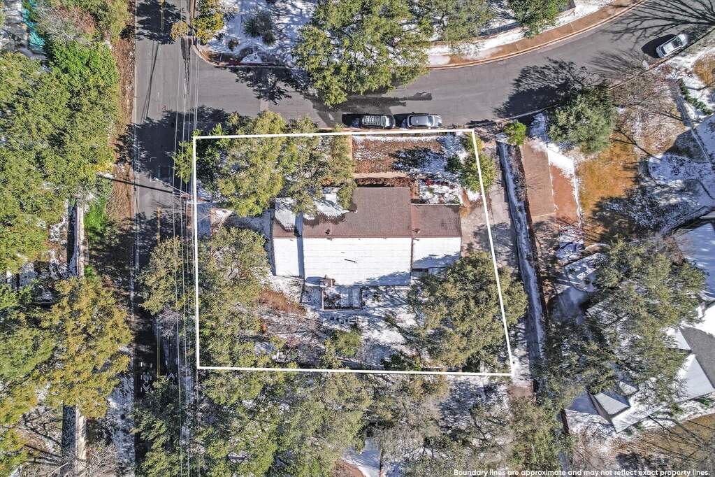 Large corner lot has SF3 zoning for future development options. Permitted plans for two new construction homes may convey with the sale.