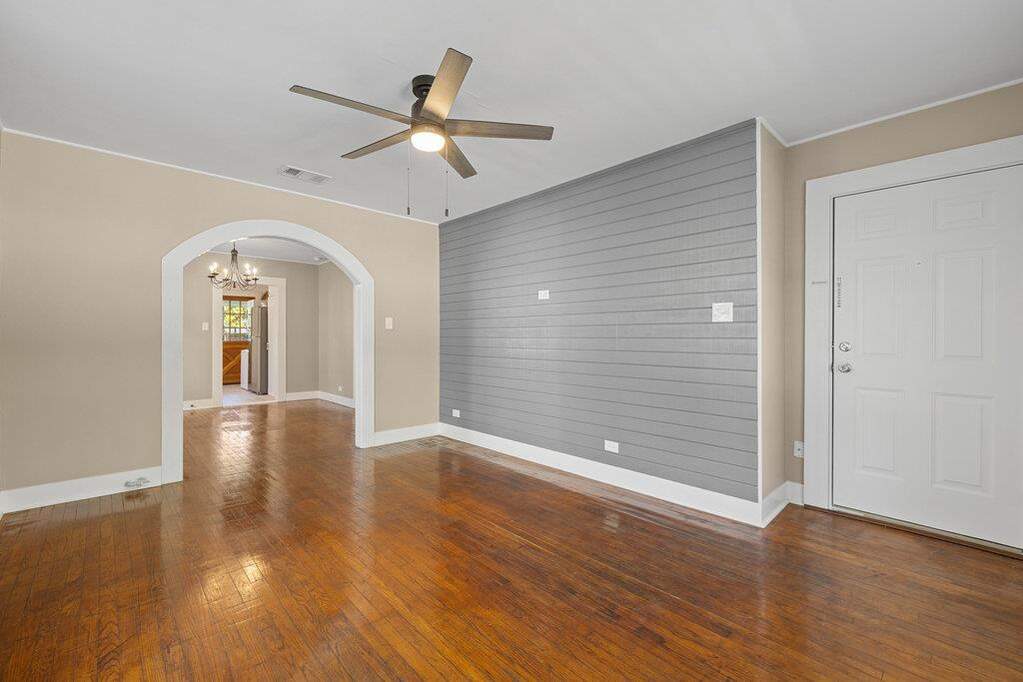 1223 living room with accent wall, arched opening to dining room. (Front door on right in photo)