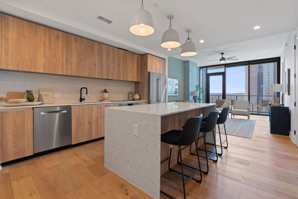 Representative Photo. Kitchen featuring custom Italkraft cabninetry, terrazzo backsplash, waterfall-edge terrazzo countertops, stainless steel Bosch appliances, and pendant lighting above kit
