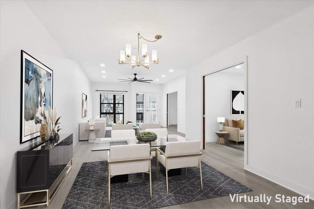 Dining area featuring light wood-type flooring, a chandelier, and recessed lighting