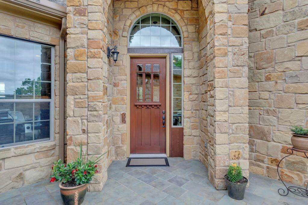 Doorway to property with stone siding