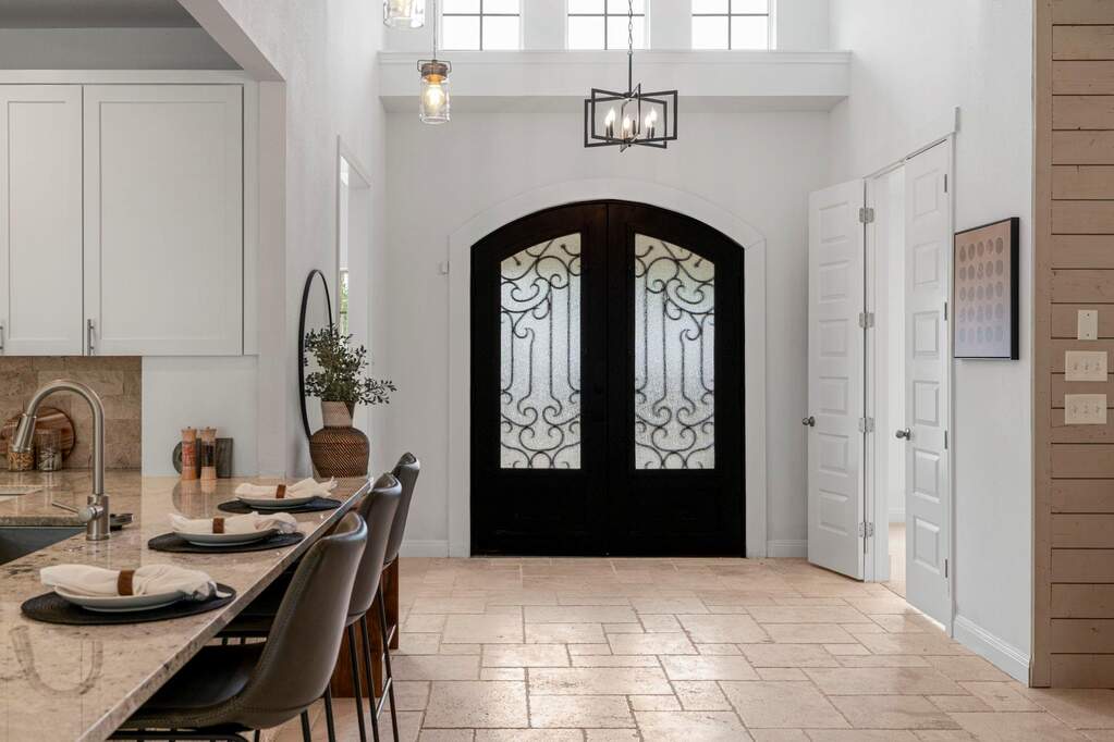 Standing at the entry, you can really see the "wow" factor. Those arched double doors with the iron scrollwork are just beautiful against the white walls and high ceilings. It sets such a sop
