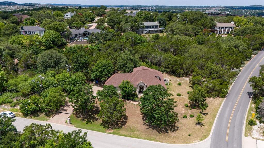 Driveway entrance on left side of property.