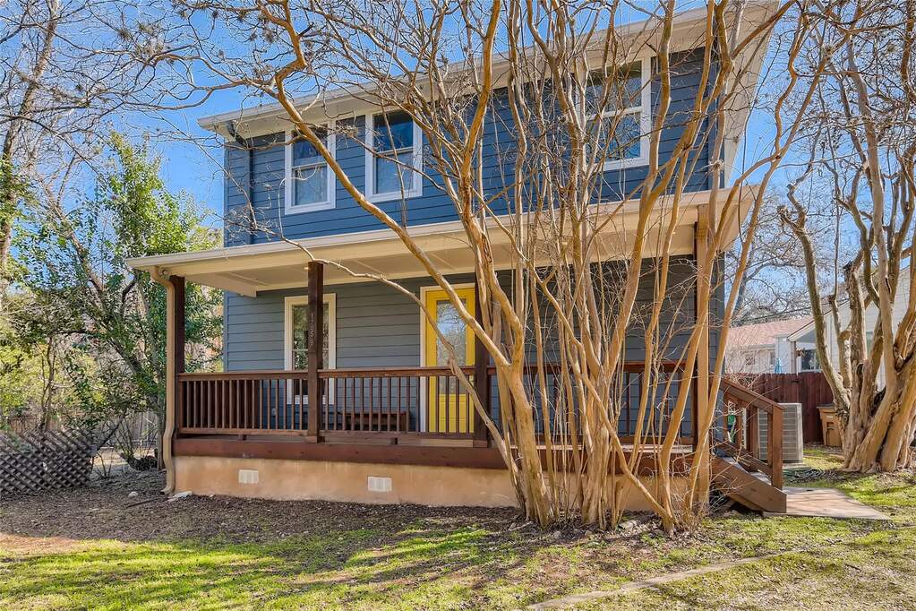 View of front of home with crawl space and a porch