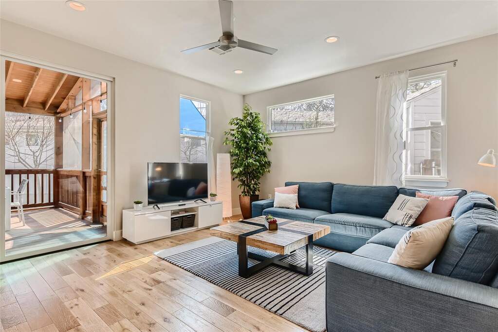 Living area featuring light wood-style flooring, recessed lighting, and ceiling fan
