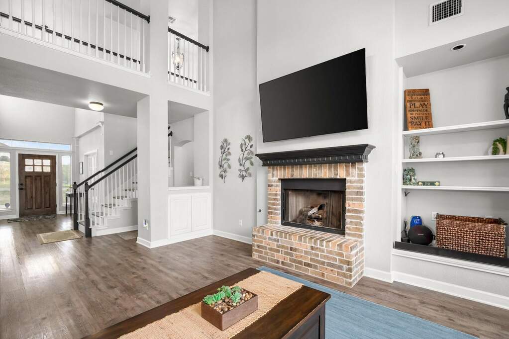 The living room features built-ins, perfect for books or decor, and a cozy brick fireplace