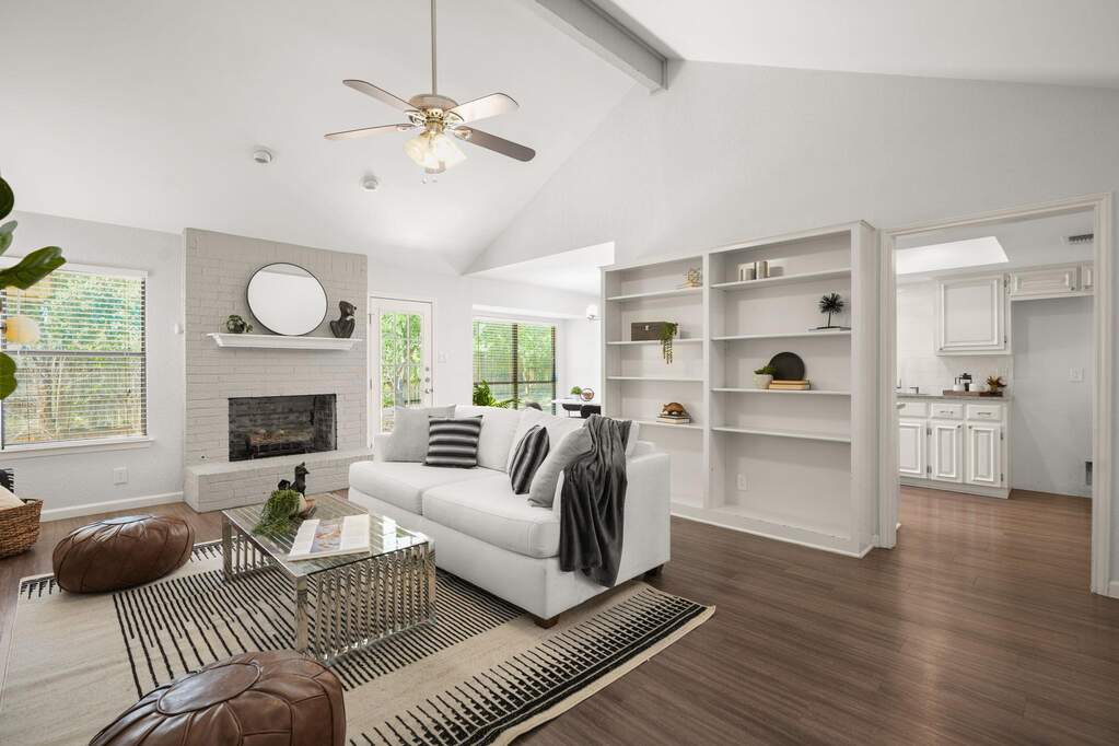 The living room is the heart of the home, complete with a fireplace for crazy nights, built-in bookshelves for your favorite reads and knick knacks, vaulted ceilings, and open to the kitchen 