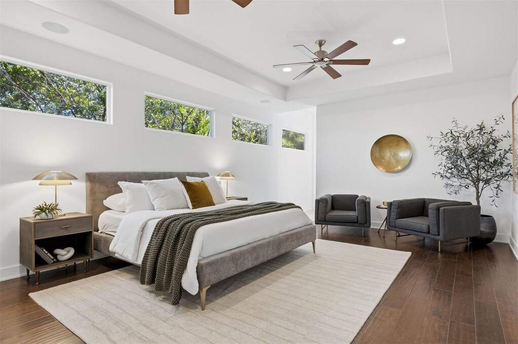 Tucked away at the back of the home for ultimate privacy, the oversized primary suite serves as a quiet, peaceful space to wind down at the end of the day