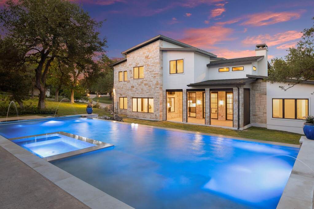 Pool with a retractable cover and below surface spa.