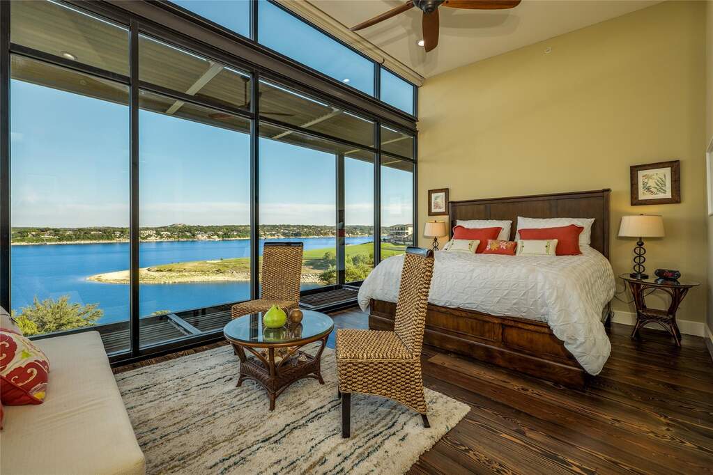 The primary suite gets the same treatment, with its own wall of glass and a wake-up view that feels almost unfair.
