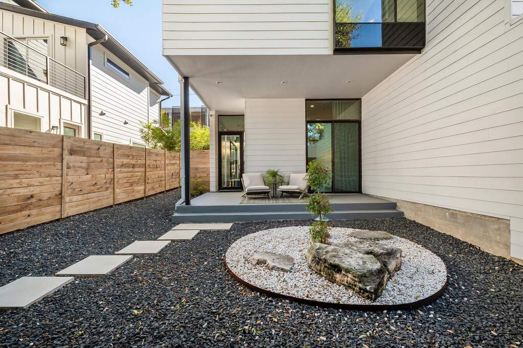 Welcoming entry framed by modern architecture and thoughtful landscaping