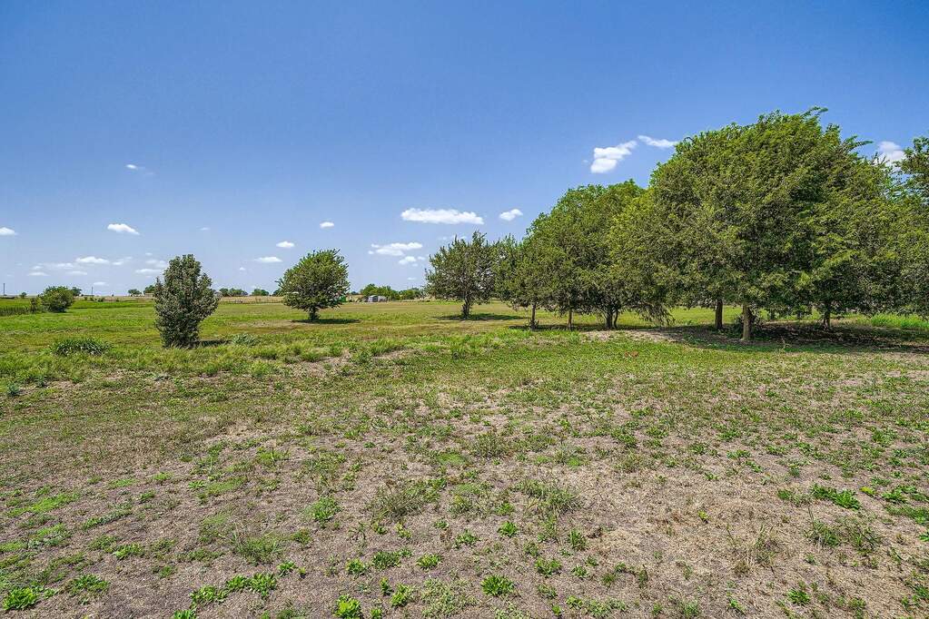 View of yard with a rural view