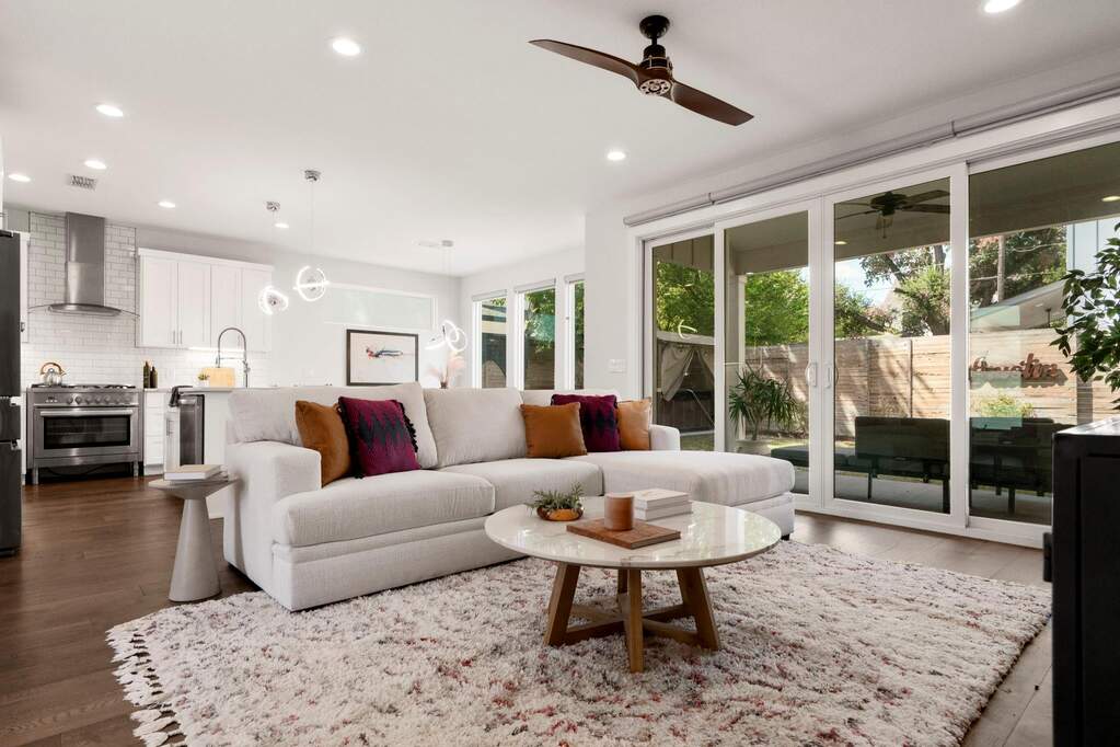 Inside, the open floorplan allows for both ease and occasion. The open kitchen–dining–living ensemble invites everyday gathering and spirited hosting with a natural flow to the yard.
