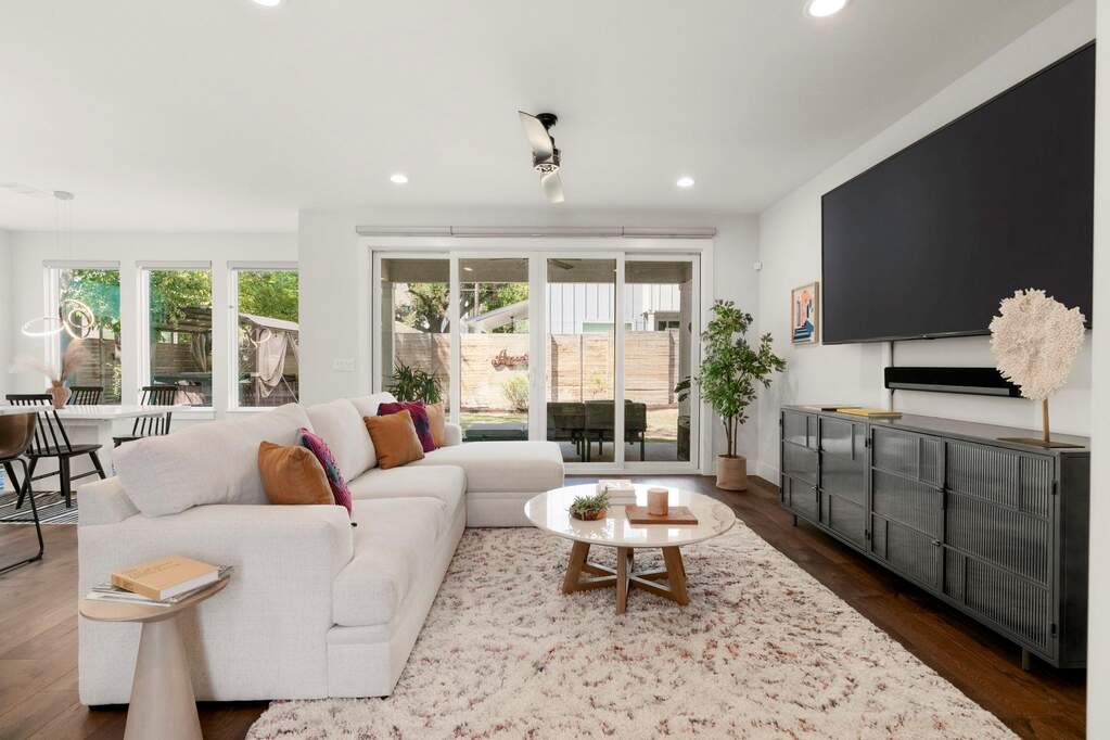 Inside, the open floorplan allows for both ease and occasion. The open kitchen–dining–living ensemble invites everyday gathering and spirited hosting with a natural flow to the yard.
