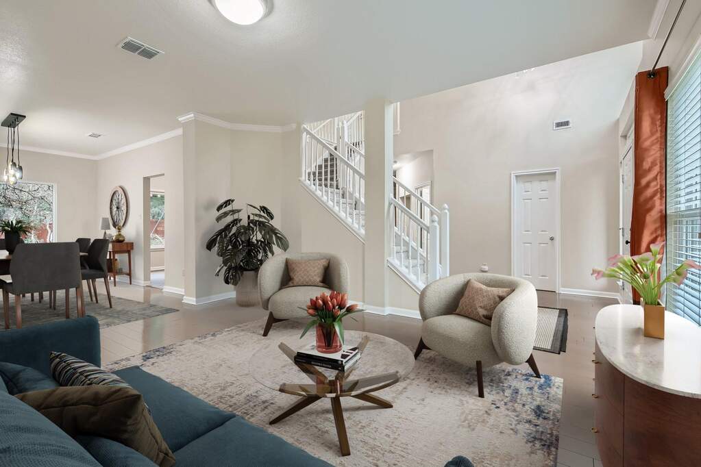An open floorplan seamlessly connects the well-lit living area to a formal dining space.