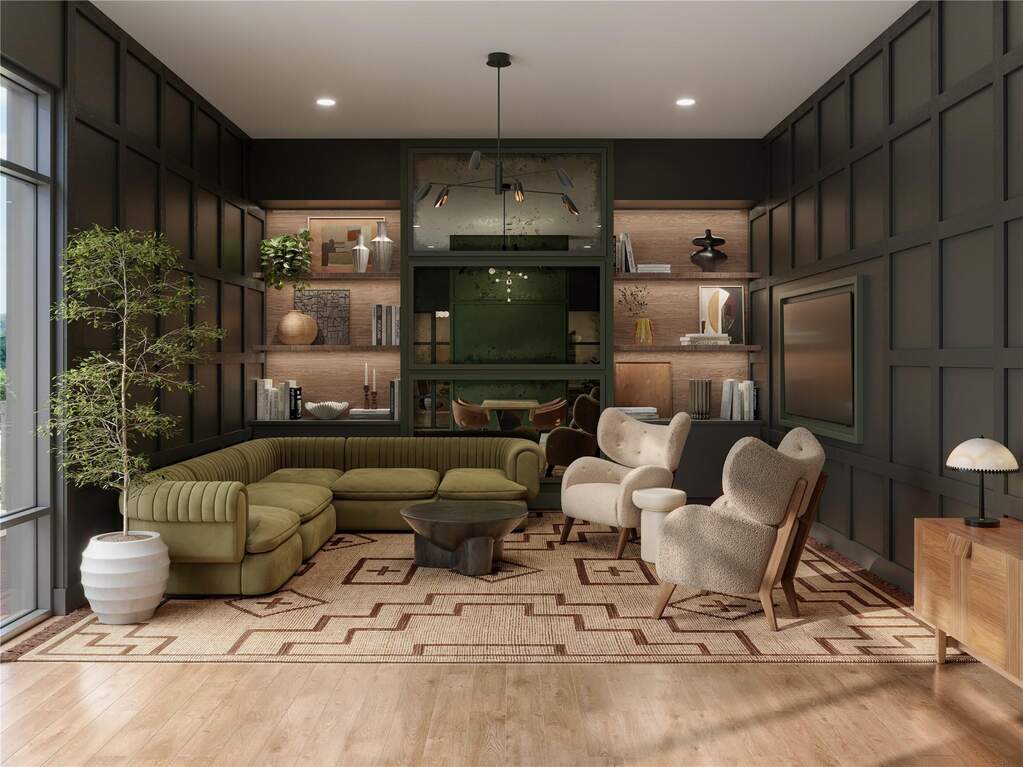Modern resident lounge with comfortable seating, integrated screen, and flexible spaces for quiet work, meetings, or small gatherings. Designed with custom millwork and warm lighting to creat