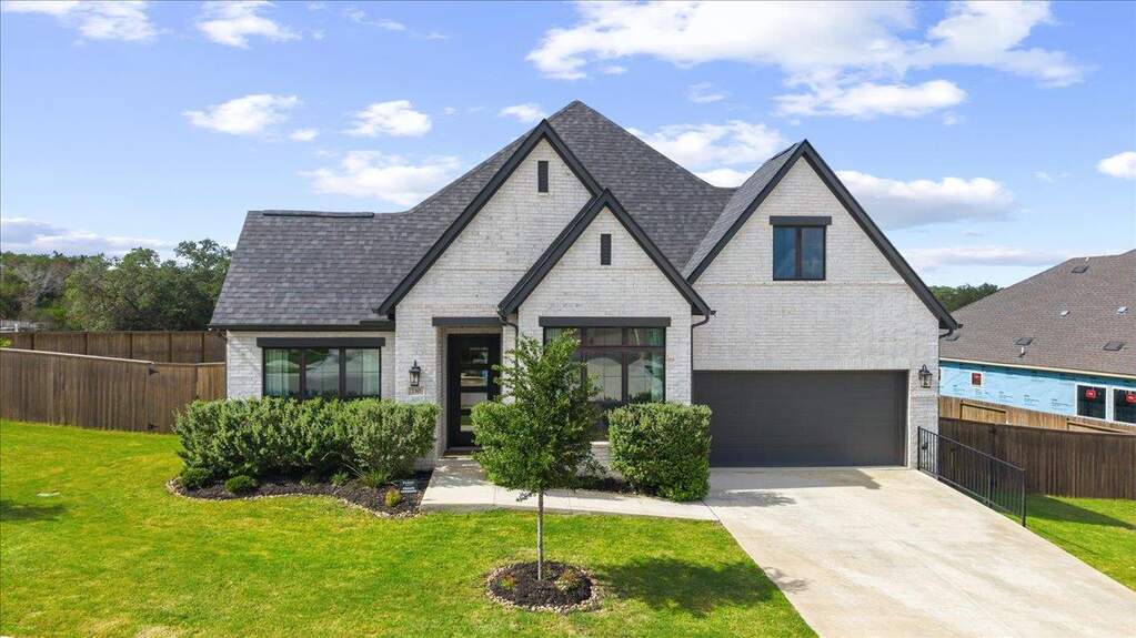 Sleek curb appeal, a huge corner lot, and that crisp black-and-white exterior moment.