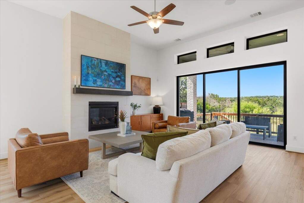 The living room opens right to the covered patio, with sliding glass doors that pull the view straight into the room.