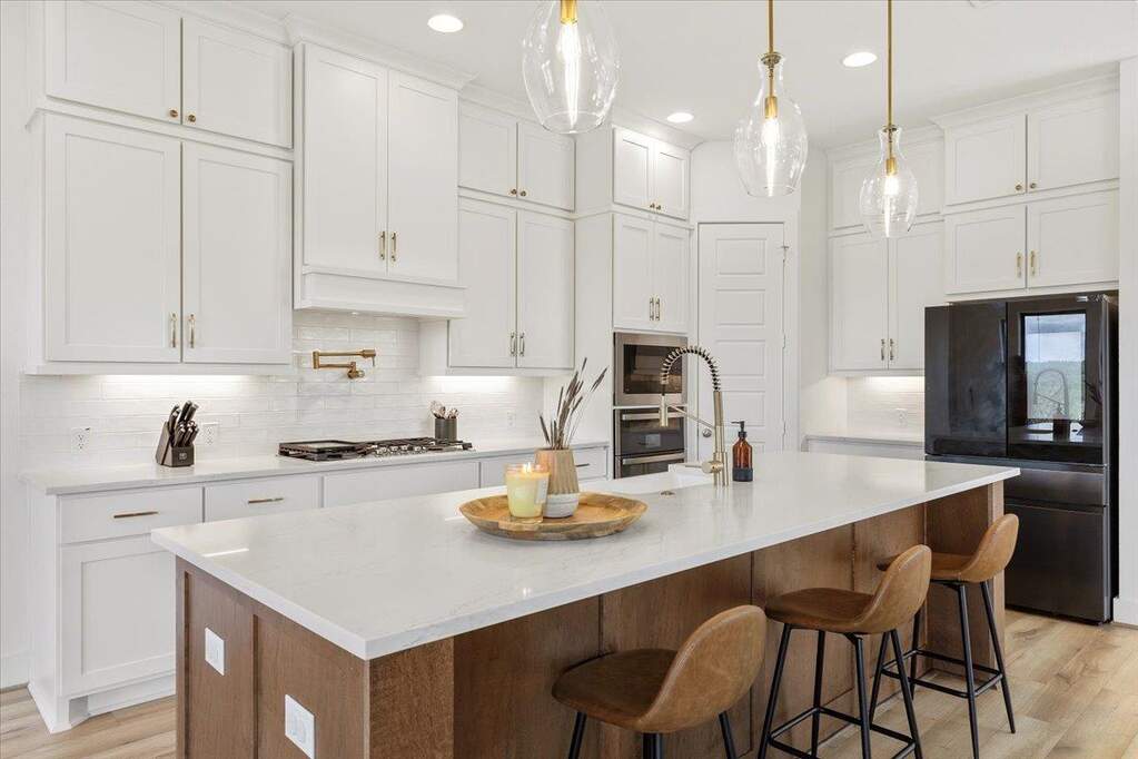 This kitchen showed up with a huge island, ceiling-height cabinetry, and plenty of space to gather.