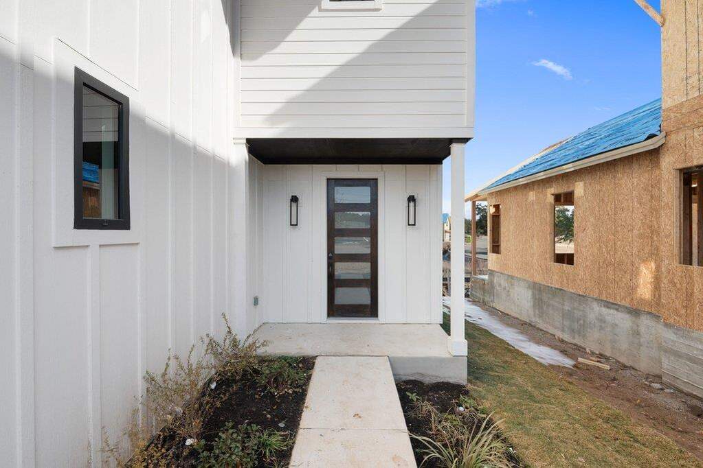 Doorway to property featuring board and batten siding