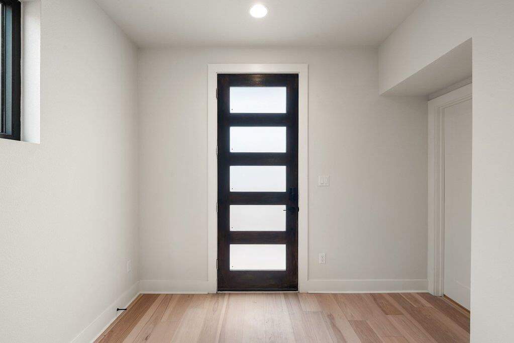 Entryway with light wood-type flooring and recessed lighting