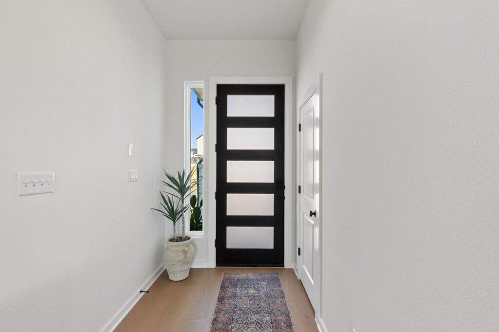 Modern black entry door with five frosted glass panels