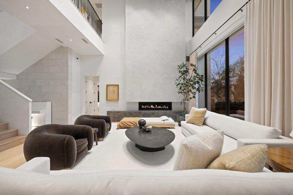 Living area featuring a premium fireplace and a high ceiling